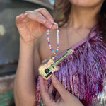 Someone holding the Merry Era Friendship Bracelet Ornament.