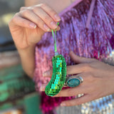 Someone holding the Disco Pickle Ornament.