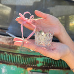 Someone holding the Glinda inspired ornament from the Emerald City 2 Piece Ornament Set.