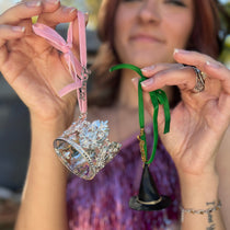 Someone holding the Emerald City 2 Piece Ornament Set.