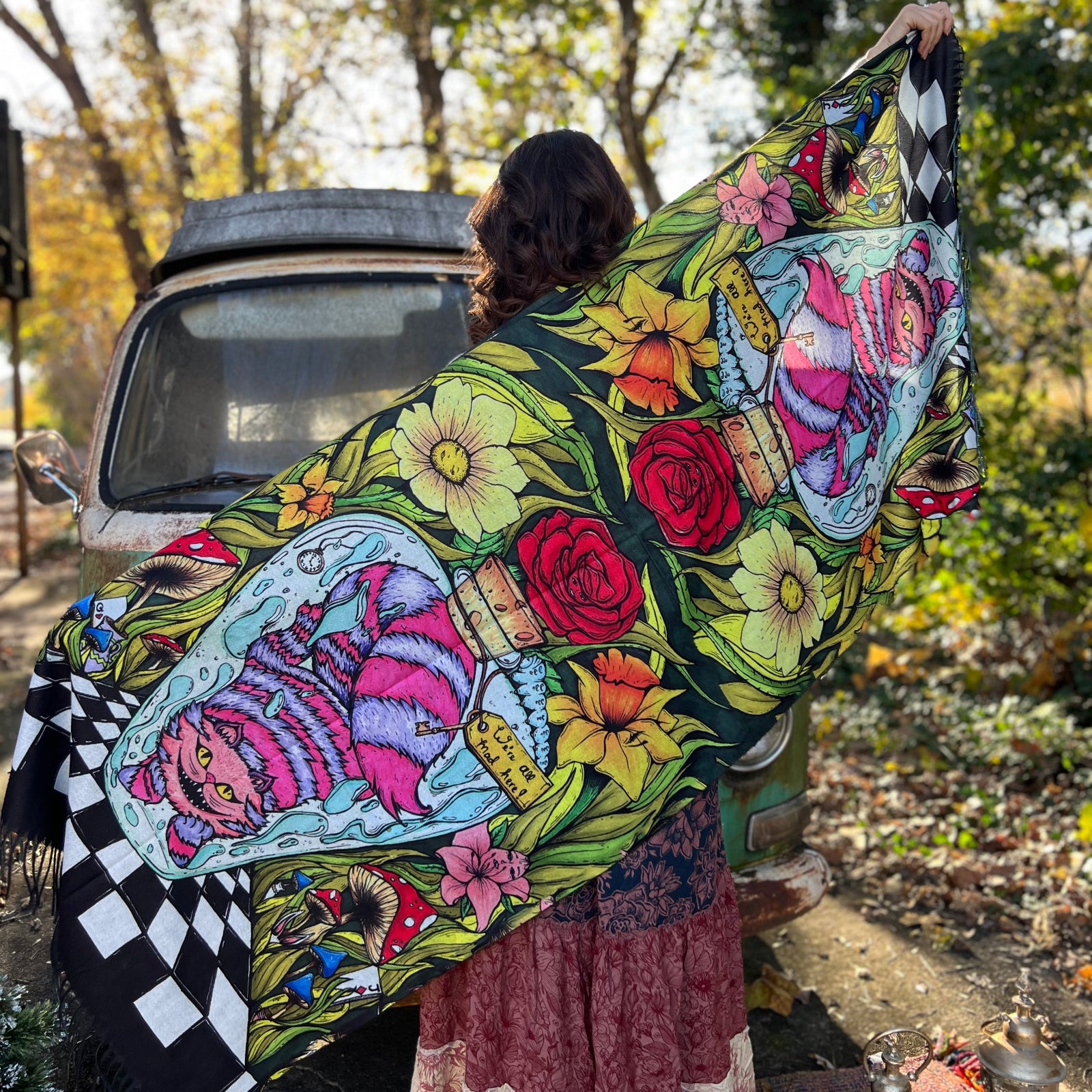A woman holding the Cheshire Inspired Pashmina showing off the full design.