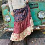 Someone wearing the  witCactus Garden Tiered Maxi Skirt a beige skirt in front of a vintage Volkswagen bus.
