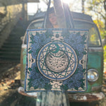 Someone holding a Sun Bandana Blue Canvas Tote Bag in front of themselves.