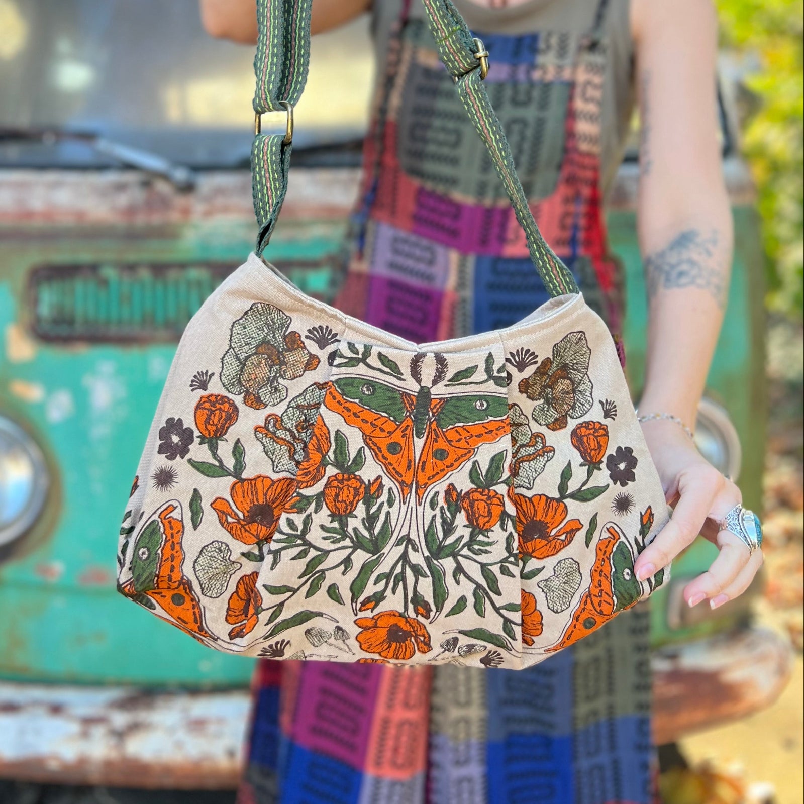 Someone holding the Luna Moth Print Cotton Bag in front of themselves.