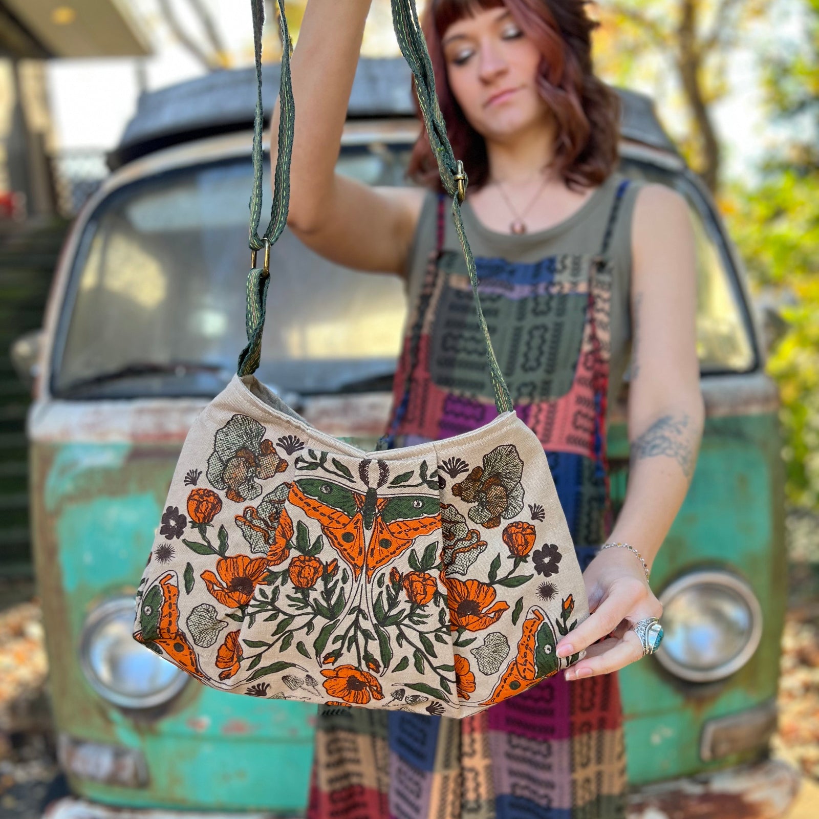 Someone holding the Luna Moth Print Cotton Bag in front of themselves.