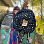 Someone holding the Tiny Moon Celestial Backpack in front of themselves.