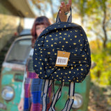 Someone holding the Tiny Moon Celestial Backpack in front of themselves.