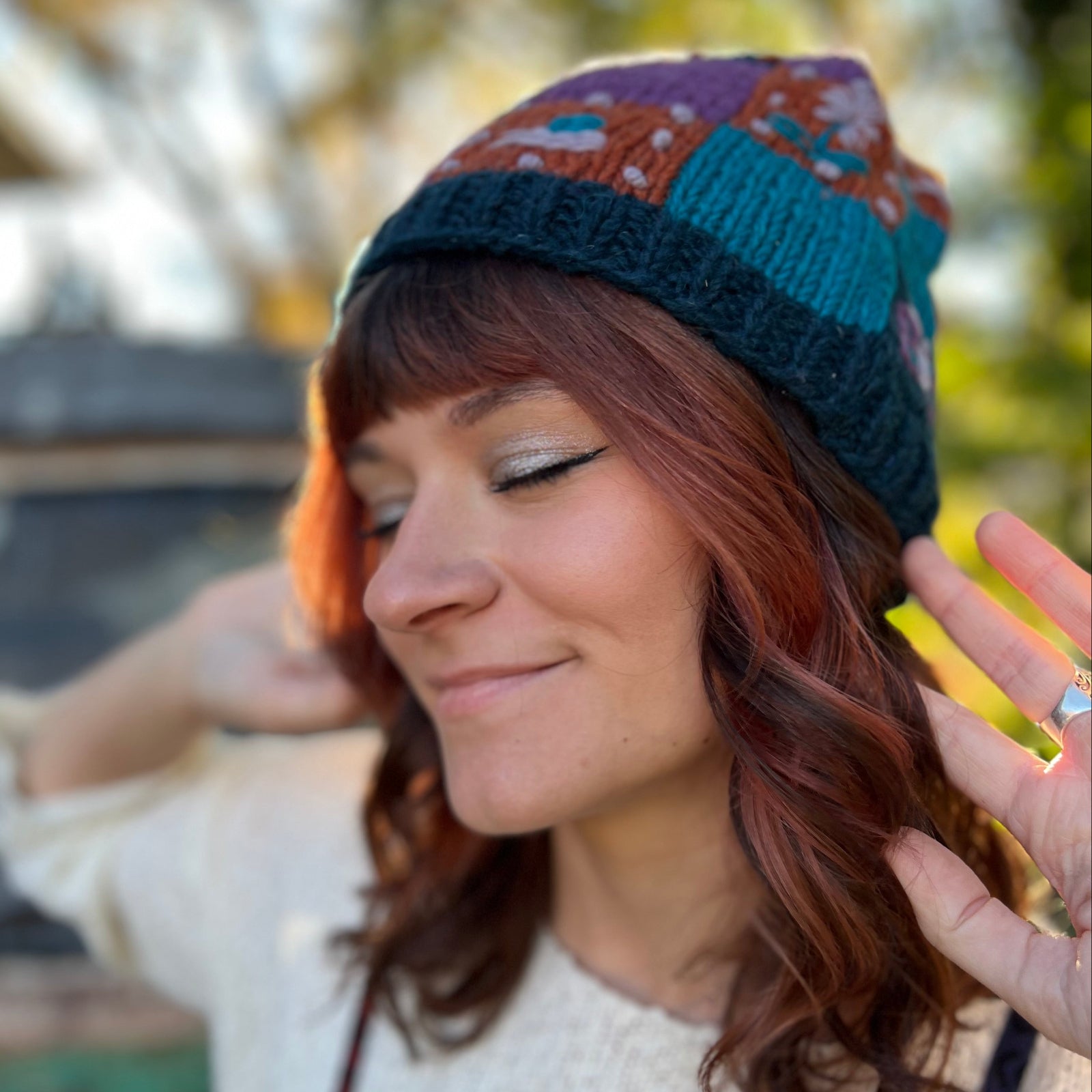 A woman wearing the Knit Patchwork Cottagecore Wool Beanie.
