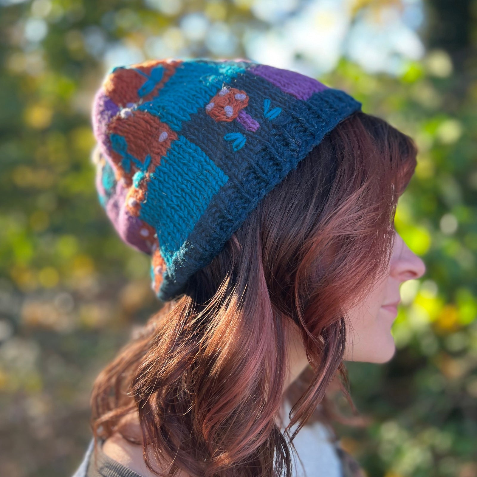 A woman wearing the Knit Patchwork Cottagecore Wool Beanie.