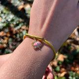 Someone wearing the Adjustable Gold & Pink Evil Eye Protection Bracelet.