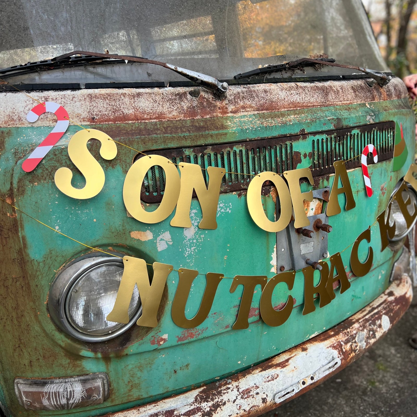 The Son of a Nutcracker Gold Foil Banner on a vintage Volkswagen bus.