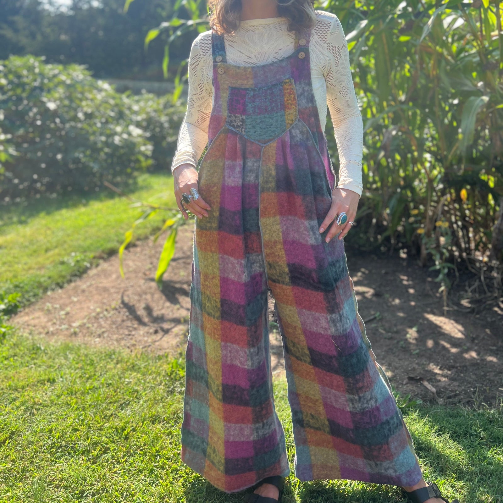 A woman wearing the Vintage Brushed Checkered Overalls with a white long sleeve.