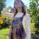A woman wearing the Vintage Brushed Checkered Overalls with a white long sleeve.