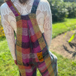 A woman wearing the Vintage Brushed Checkered Overalls with a white long sleeve.