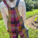 A woman wearing the Vintage Brushed Checkered Overalls with a white long sleeve.