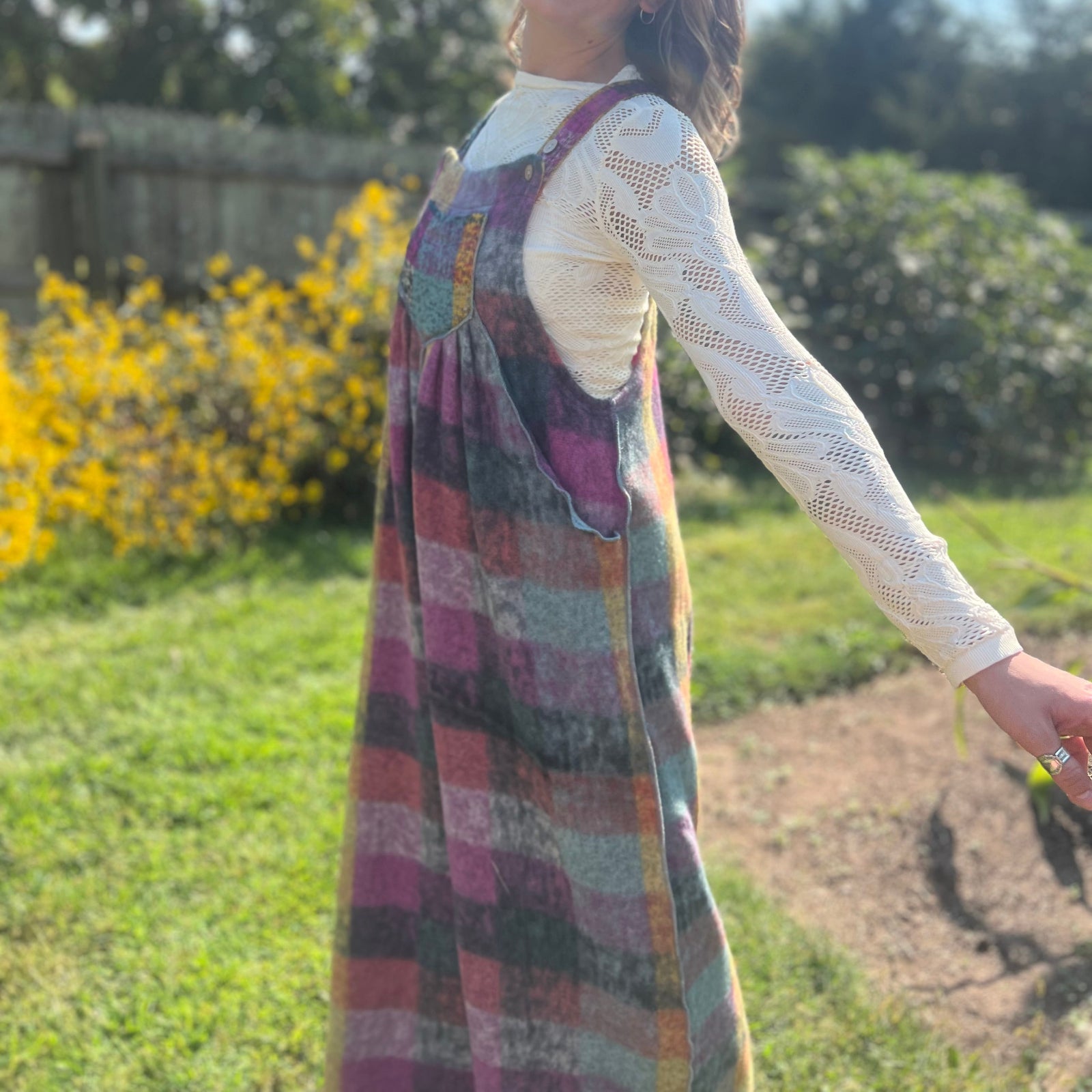 A woman wearing the Vintage Brushed Checkered Overalls with a white long sleeve.