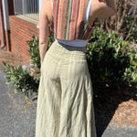 A woman wearing the sage Striped Wide Leg Cotton Pants with a white top and sandals.