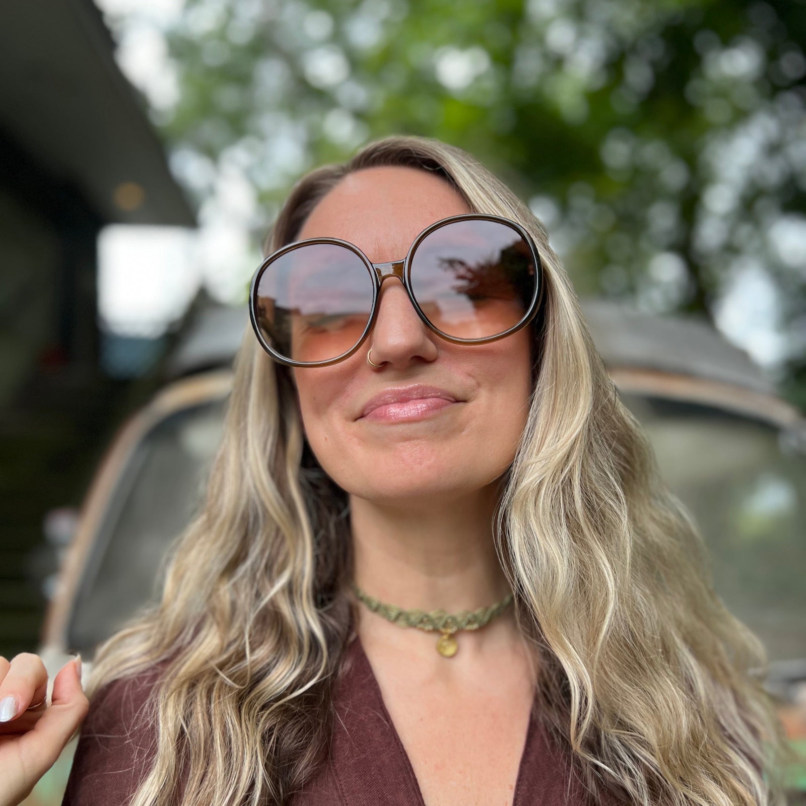 Someone wearing the juniper Bardot Seventies Round Sunglasses with a brown kimono.