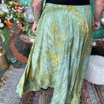 A woman wearing the green Hippie Bohemian Hand Dyed Palazzo Pants in front of a vintage Volkswagen bus.