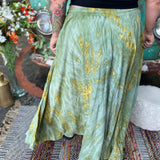 A woman wearing the green Hippie Bohemian Hand Dyed Palazzo Pants in front of a vintage Volkswagen bus.