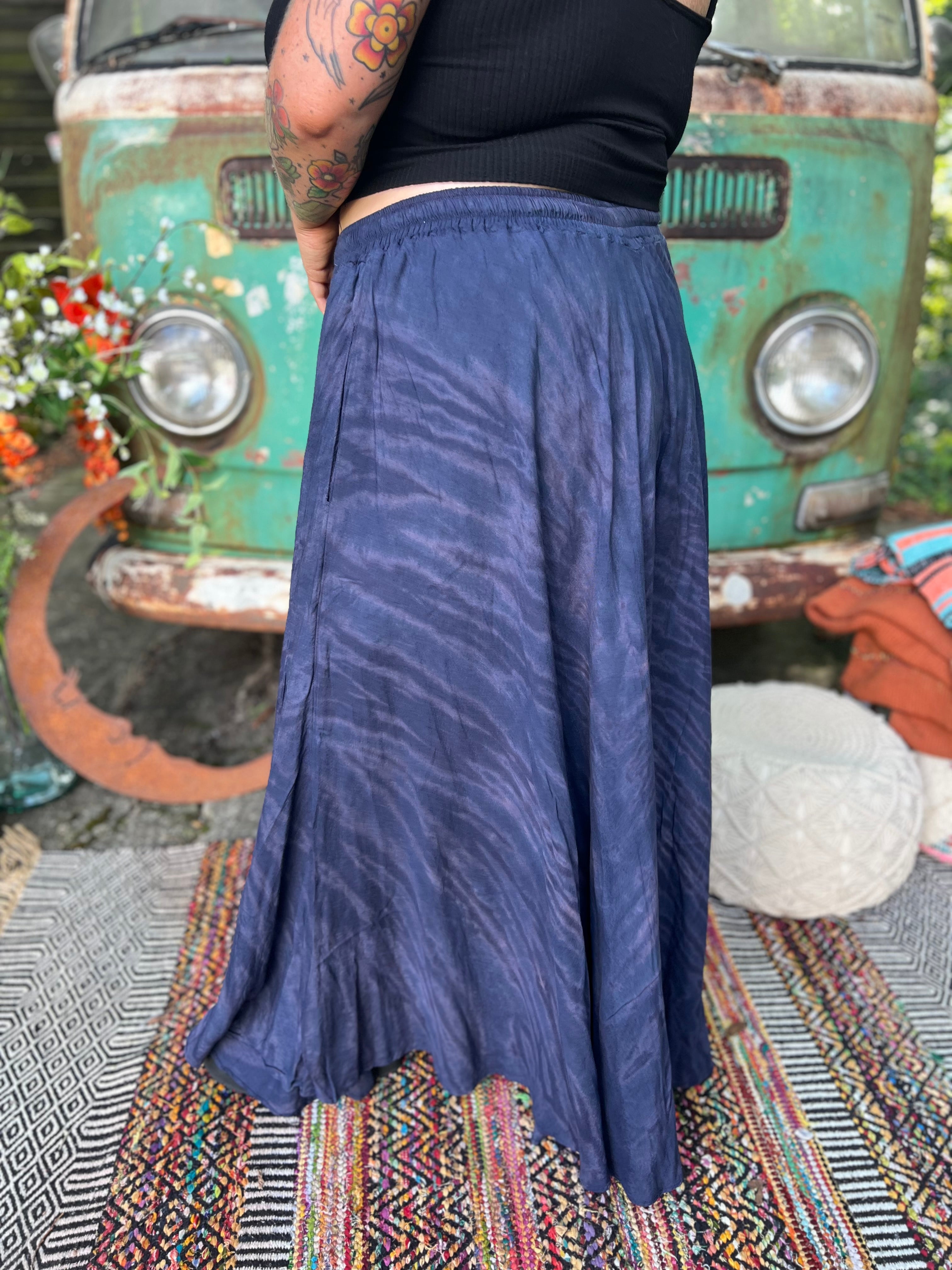 A woman wearing the navy Hippie Bohemian Hand Dyed Palazzo Pants in front of a vintage Volkswagen bus.