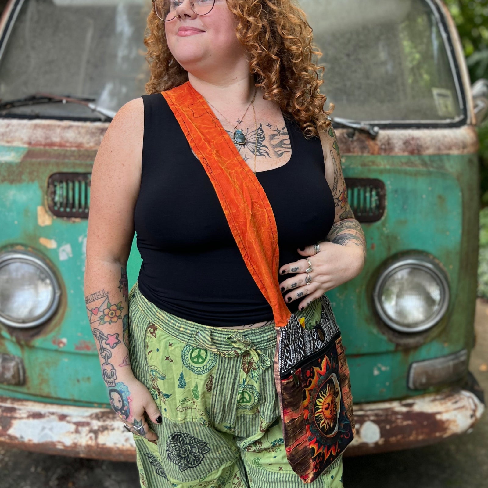 Someone wearing the Cotton Sun Moon Mini Crossbody Bag in front of a vintage Volkswagen bus.