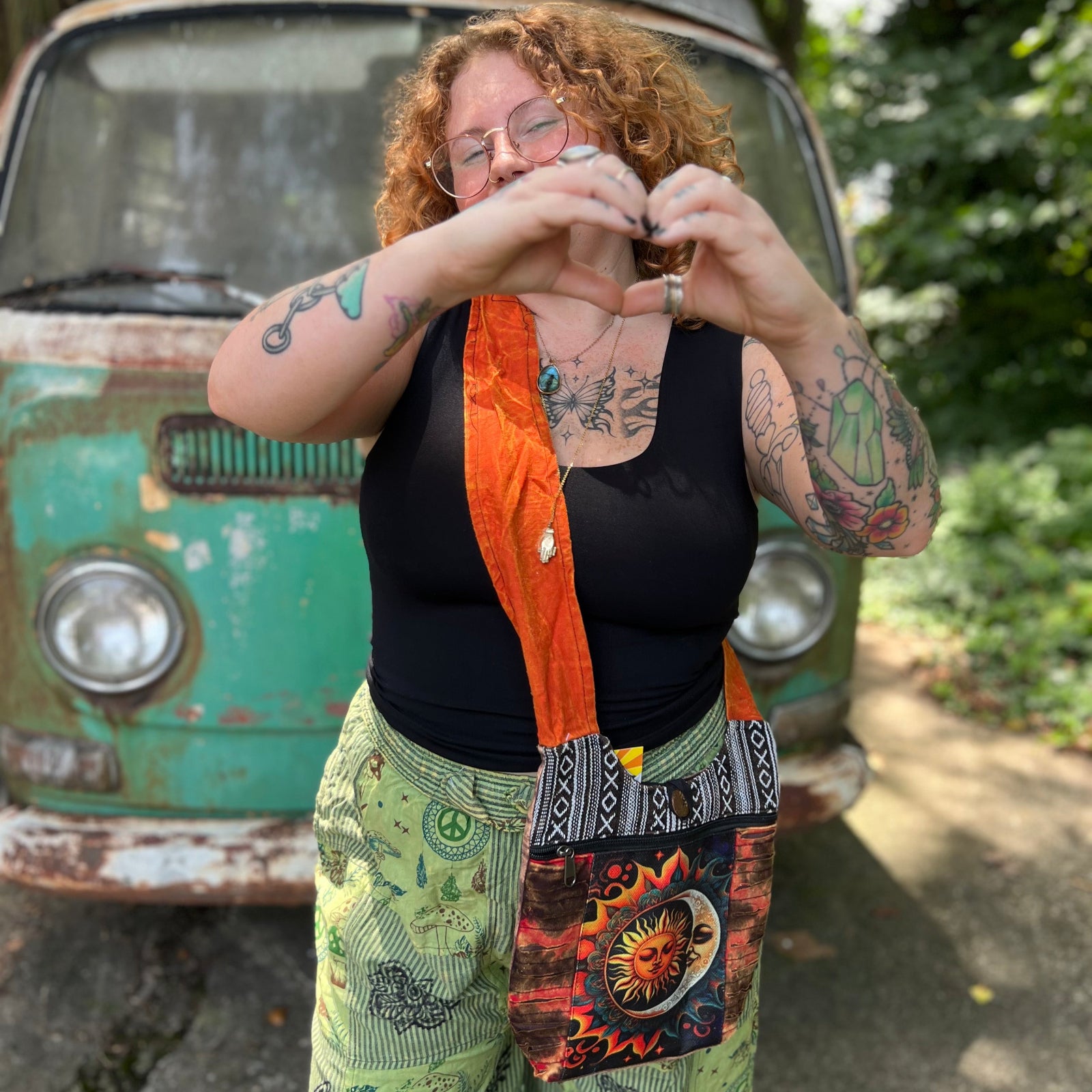 Someone wearing the Cotton Sun Moon Mini Crossbody Bag in front of a vintage Volkswagen bus.