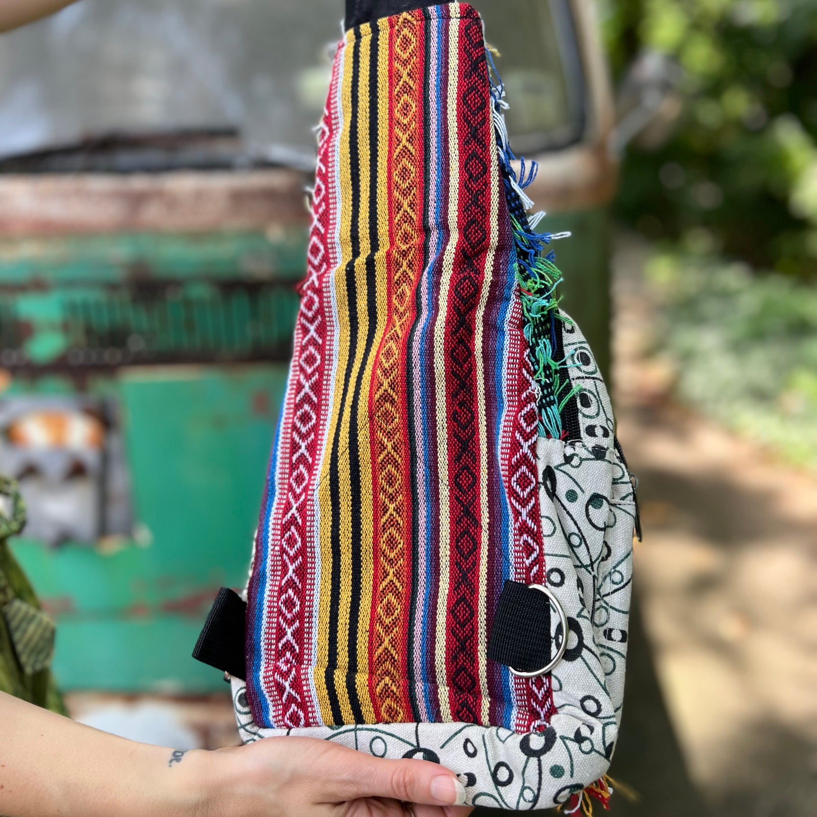 Someone holding the Cotton Multi Patch Eyelash Fringe Crossbody Bag to show off the back.