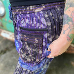 A woman wearing the Cotton Block Print Batik Cutwork Pants in front of a vintage Volkswagen bus.