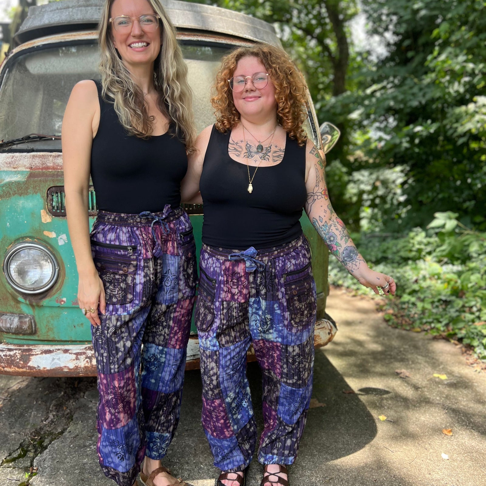 Two women wearing the Cotton Block Print Batik Cutwork Pants in front of a vintage Volkswagen bus.