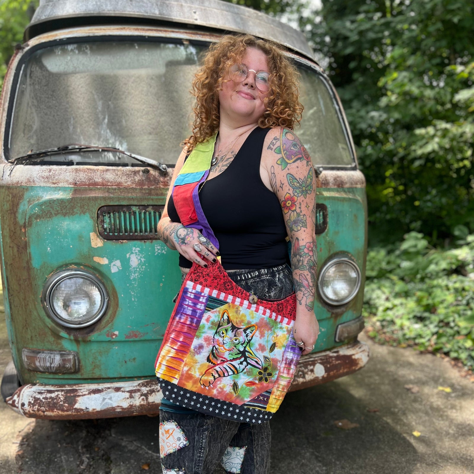 Someone wearing the Cotton Tie Dye Cat Crossbody Bag in front of the vintage Volkswagen bus.
