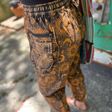 A woman wearing the Cotton Stonewash Golden Sun Moon Cargo Pant in front of a vintage Volkswagen bus.