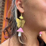 A woman wearing the pink Garden Goddess Mushroom Earrings.