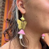 A woman wearing the pink Garden Goddess Mushroom Earrings.