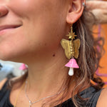 A woman wearing the pink Garden Goddess Mushroom Earrings.