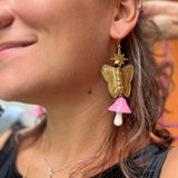 A woman wearing the pink Garden Goddess Mushroom Earrings.