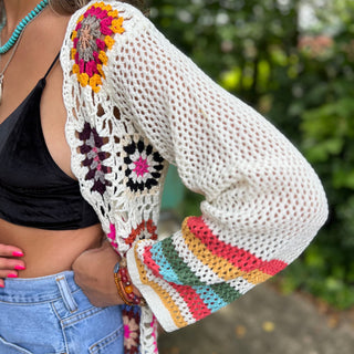 An up-close image of someone wearing the Bohemian Rainbow Crochet Cardigan.