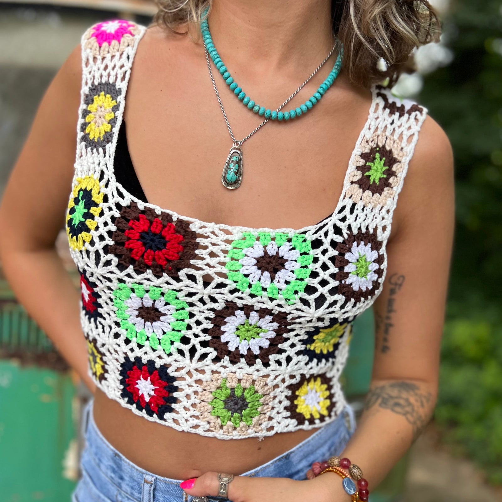 Someone wearing the white Handmade Boho Crochet Design Camisole in front of an old teal Volkswagen bus.
