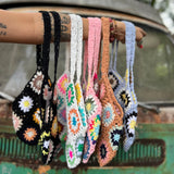 All varieties of the Bohemian Handmade Crochet Bags on an arm in front of an teal Volkswagen bus.