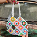 Someone holding the white Bohemian Handmade Crochet Bag in front of an old teal Volkswagen bus.