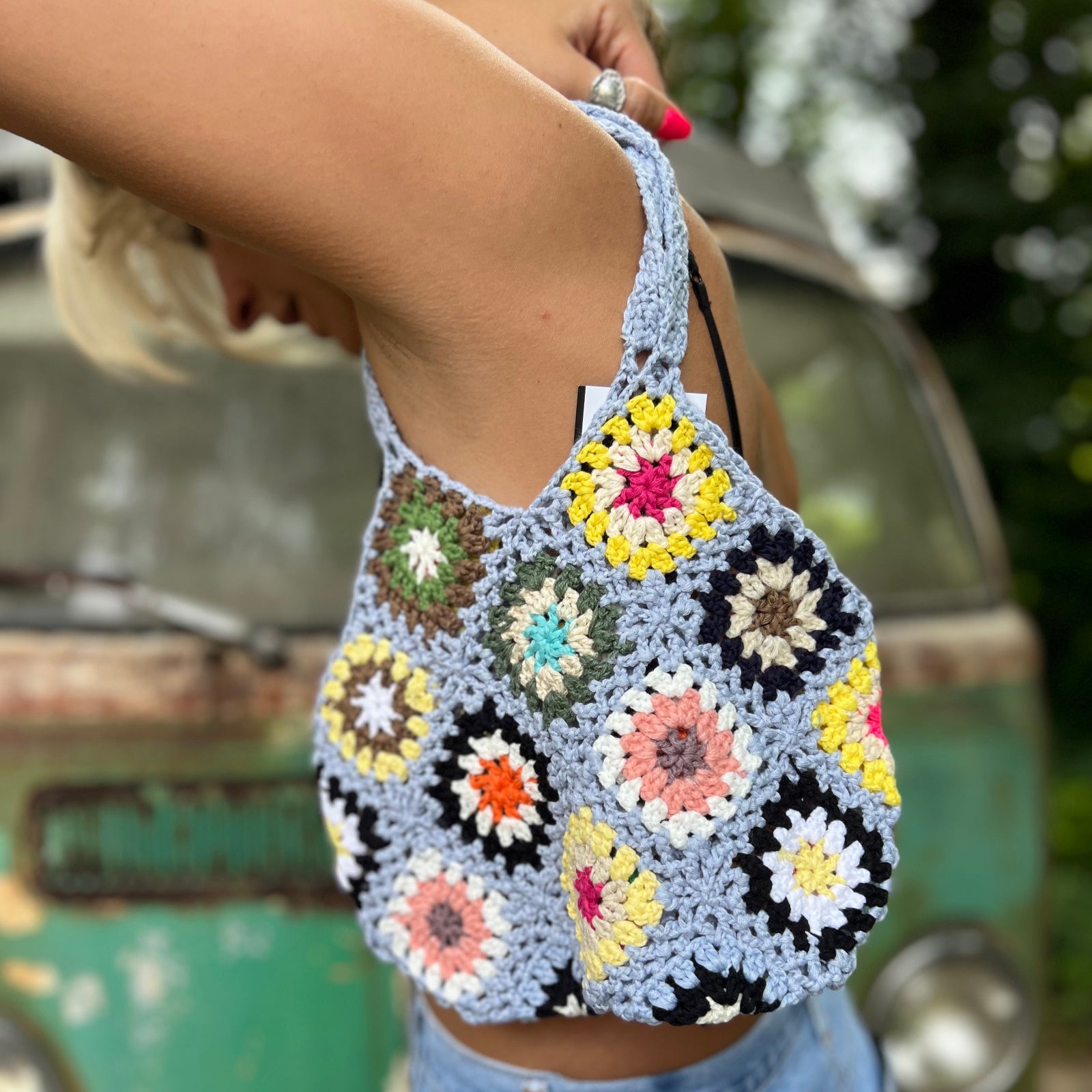 Someone wearing the blue Bohemian Handmade Crochet Bag.