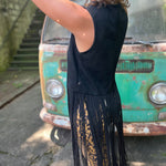 A woman wearing the black Faux Suede Long Fringe Western Vest.