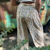 Someone wearing the Honey Linen Pants with Front Slit with a white bralette.