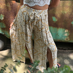 Someone wearing the Honey Linen Pants with Front Slit with a white bralette.