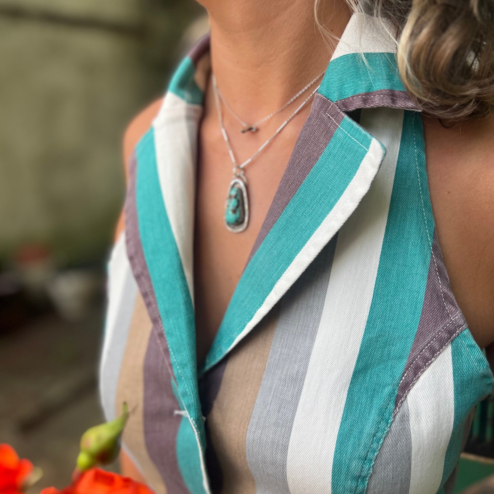 Someone wearing the turquoise multi Retro Striped Denim Halter Vest Top.