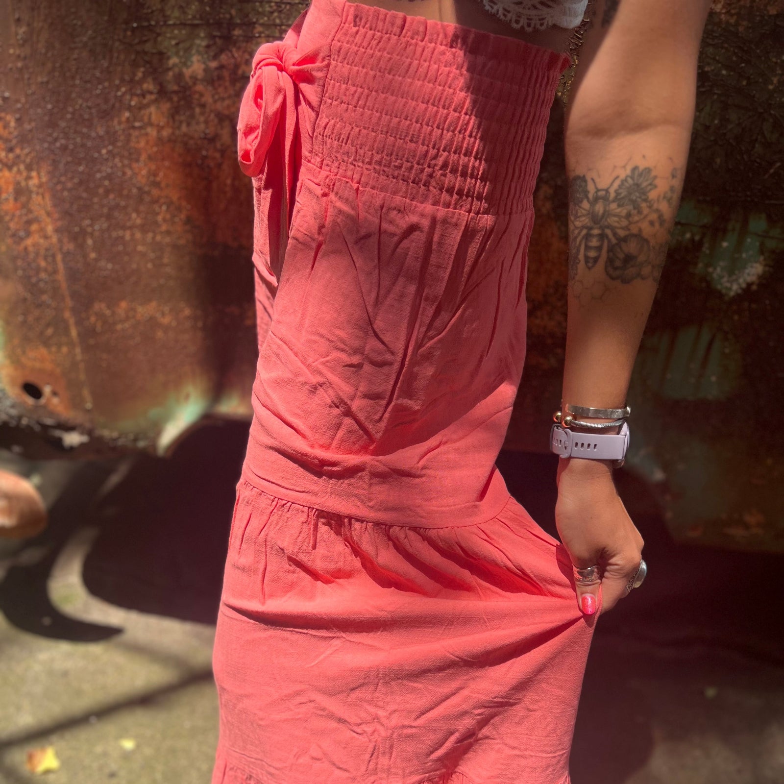 Someone wearing the coral Smocking Waist Tier Wide Pants.