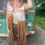 A woman wearing the camel Retro Sunburst Suede Color Block Long Fringe Faux Vest.