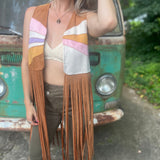 A woman wearing the camel Retro Sunburst Suede Color Block Long Fringe Faux Vest.