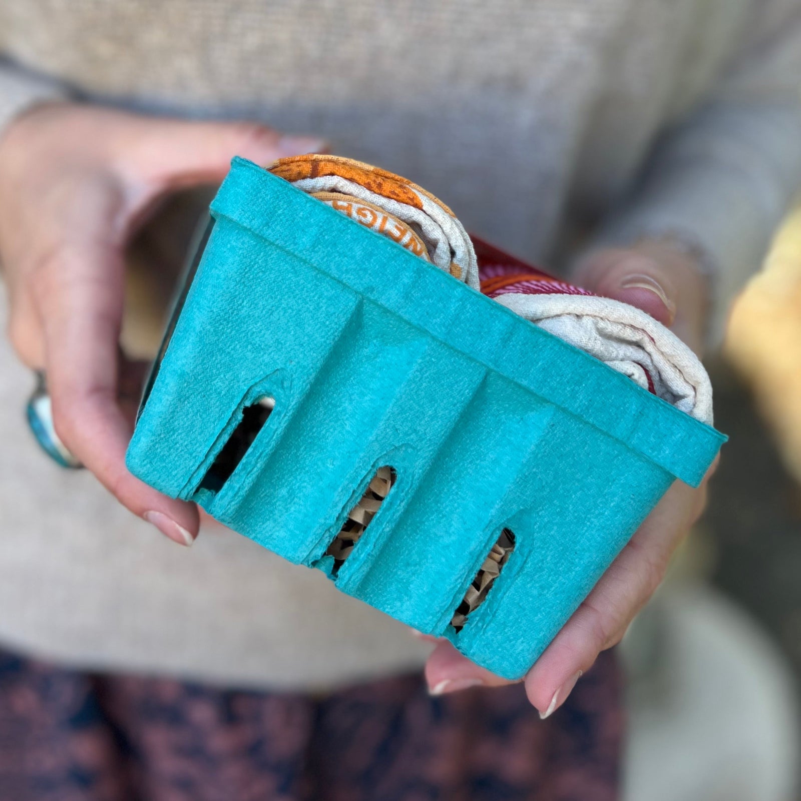 Someone holding a Tea Towel Set of 2 from The Neighborgoods, showing off the side.