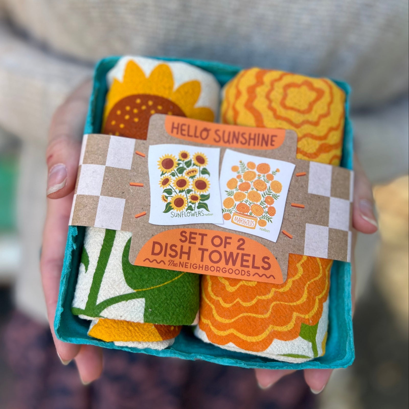 Someone holding the Hello Sunshine Tea Towel Set of 2 in front of themselves.